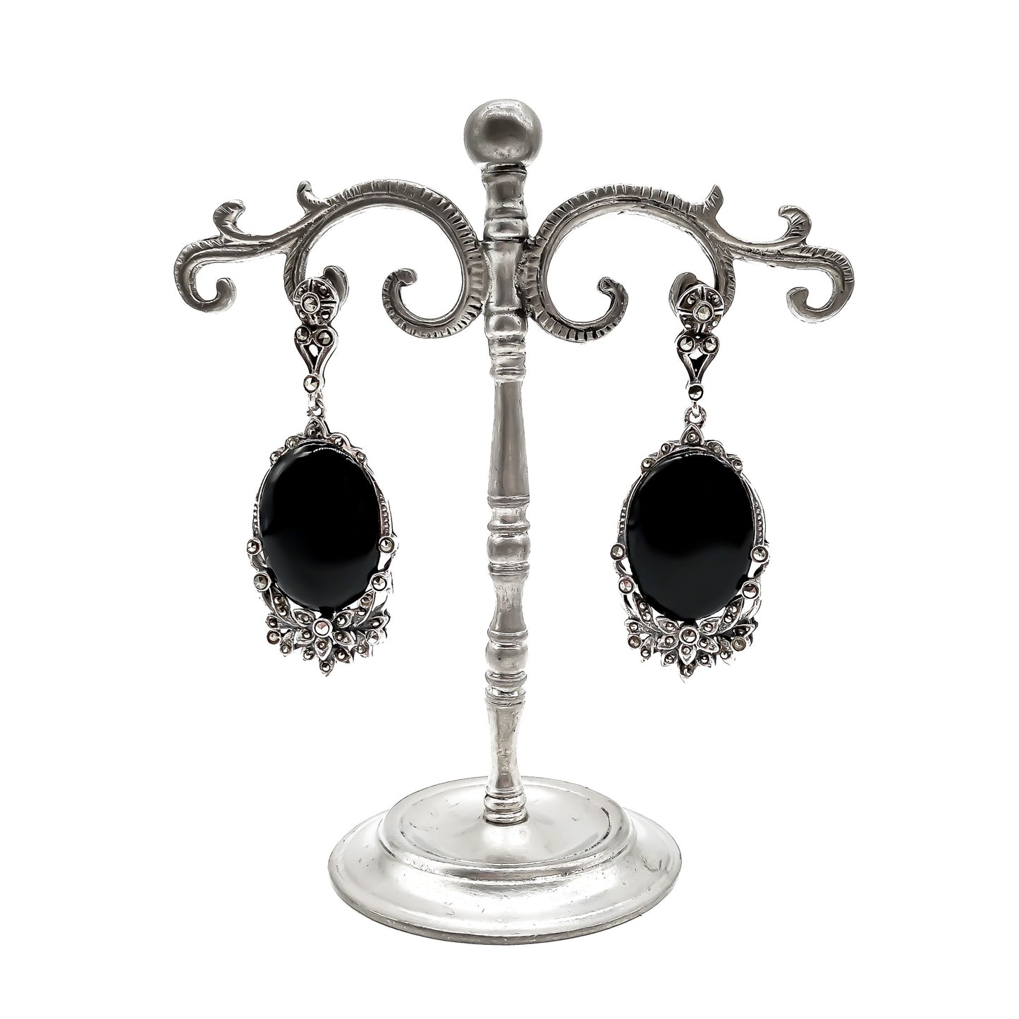 Stunning vintage silver drop earrings, each set with an oval onyx cabochon stone and marcasites in a floral design.