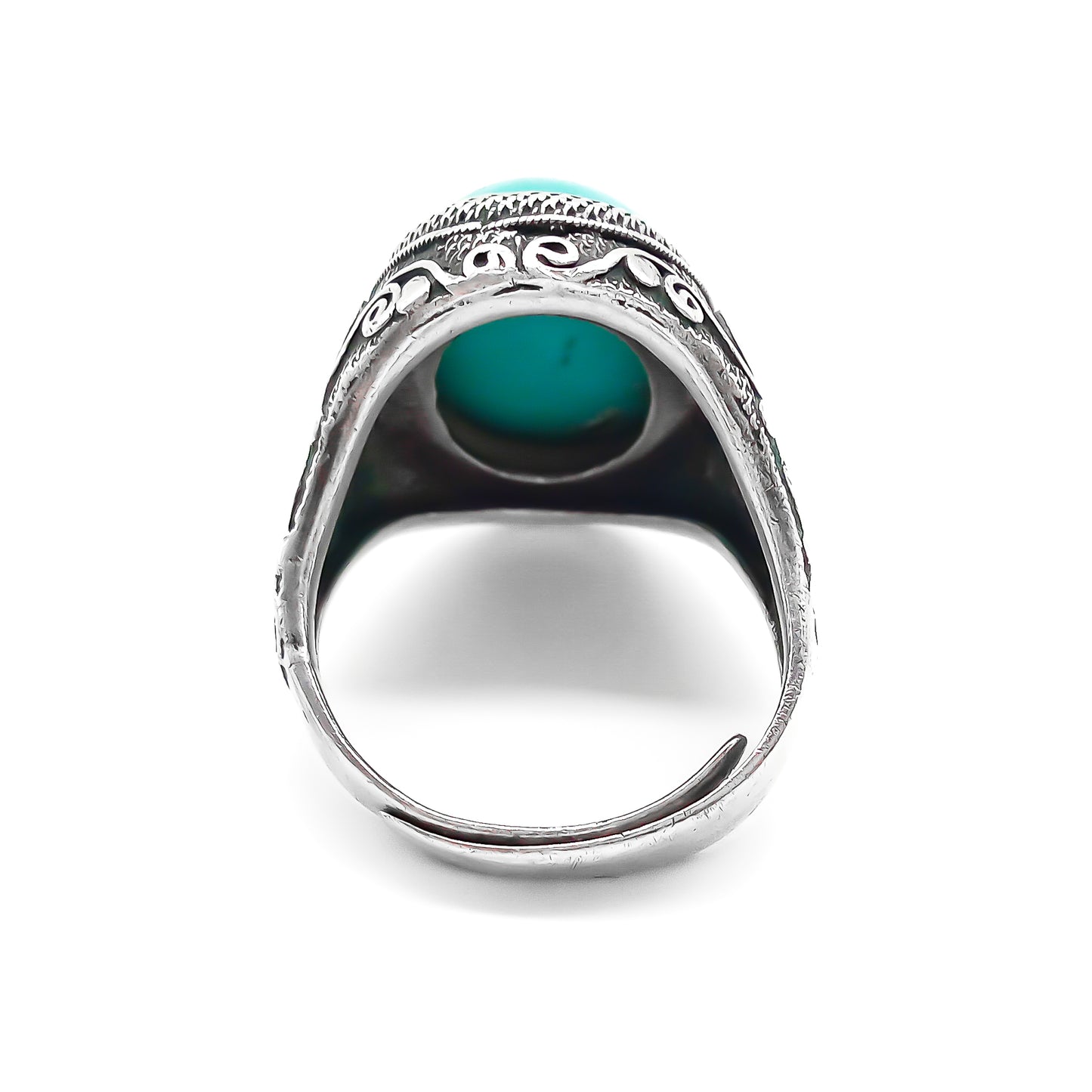 Silver ring set with a beautiful cabochon turquoise stone and ornate filigree embellishment.