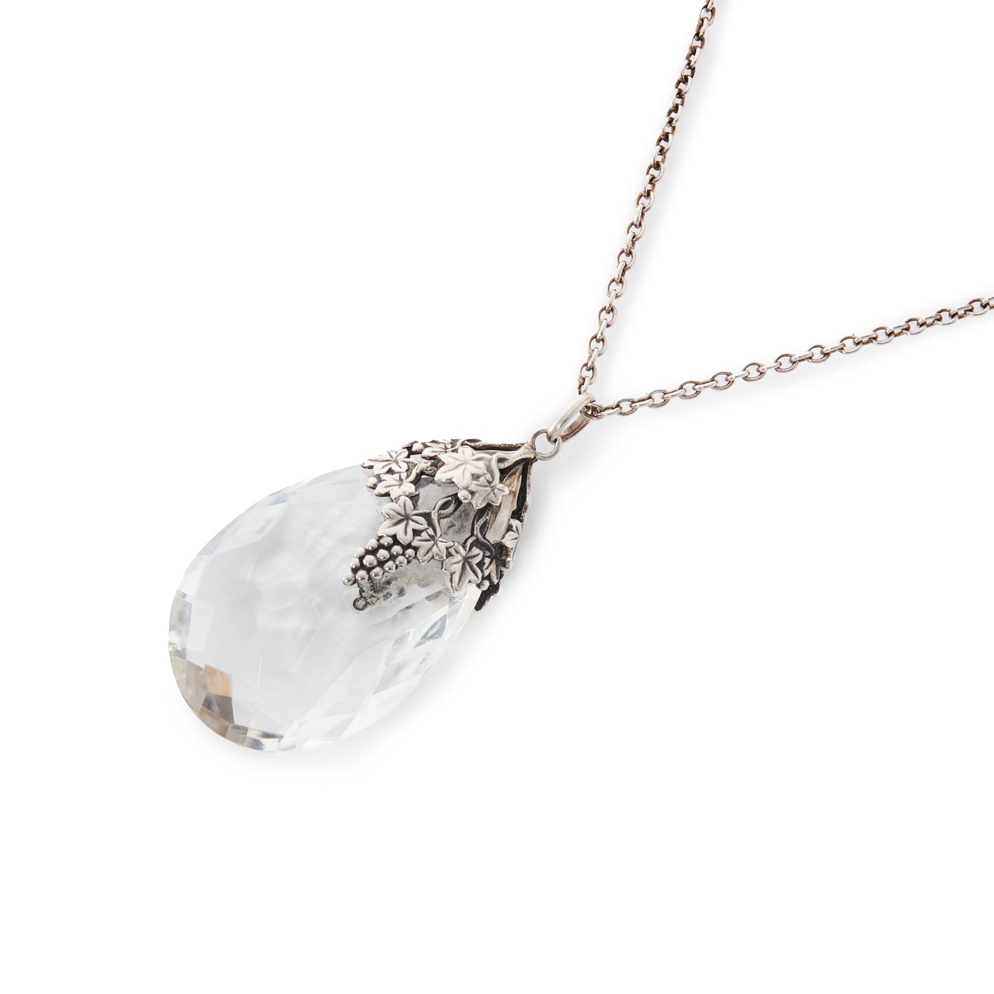 Lovely large Art Nouveau rock crystal teardrop pendant with silver grape leaf embellishment. On a silver chain.