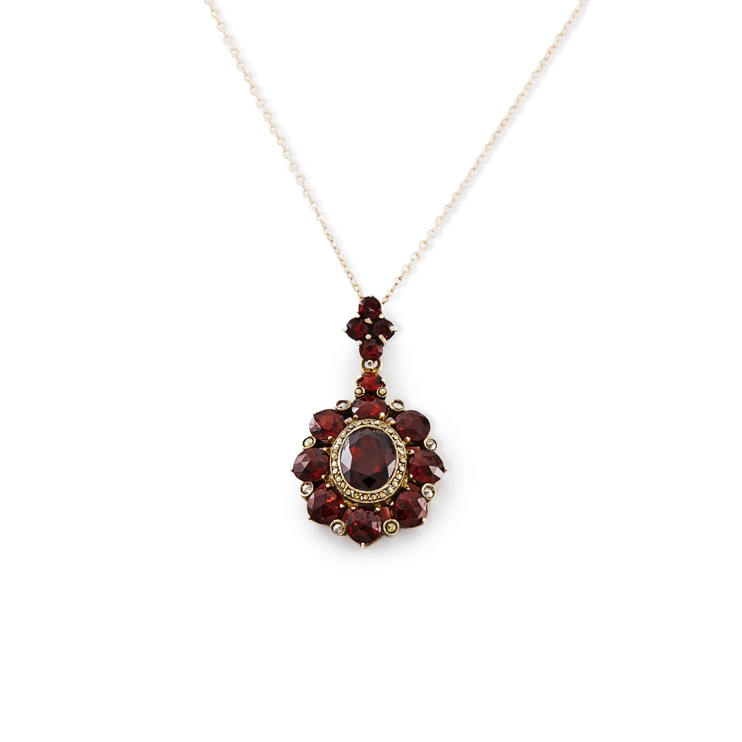 Exquisite silver gilt pendant on a silver chain, set with thirteen deep red old cut garnets and a larger oval garnet surrounded by marcasites in the centre.