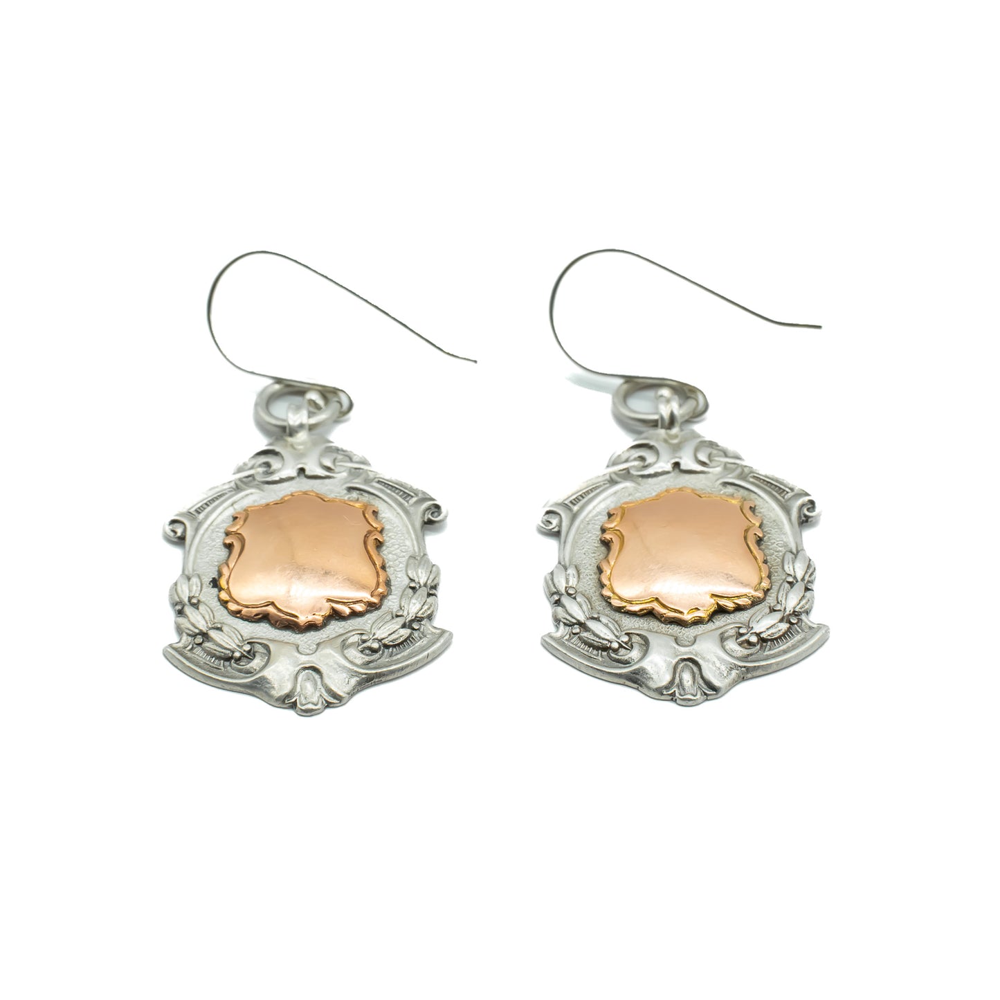 Unusual pair of ornate sterling silver medallion earrings with 9ct rose gold disks. Circa 1934