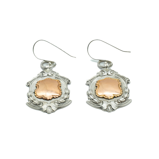 Unusual pair of ornate sterling silver medallion earrings with 9ct rose gold disks. Circa 1934
