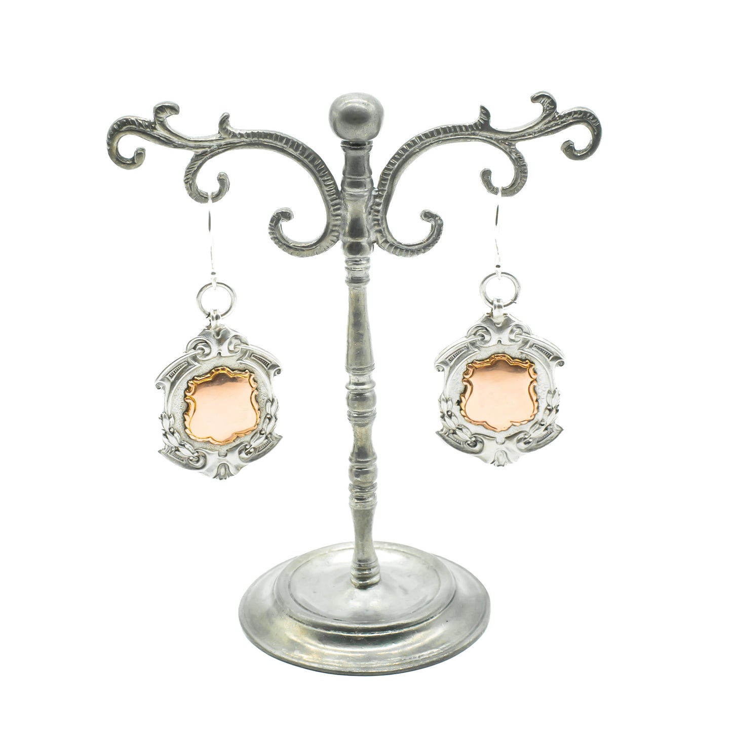 Unusual pair of ornate sterling silver medallion earrings with 9ct rose gold disks. Circa 1934