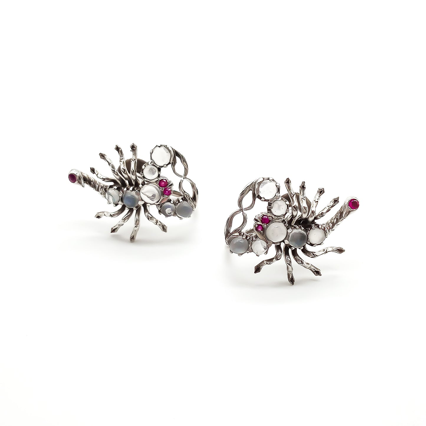 Charming silver scorpion earrings, each set with seven moonstones, ruby eyes and a ruby set in the tail. Screw-on backs.
Circa 1930’s