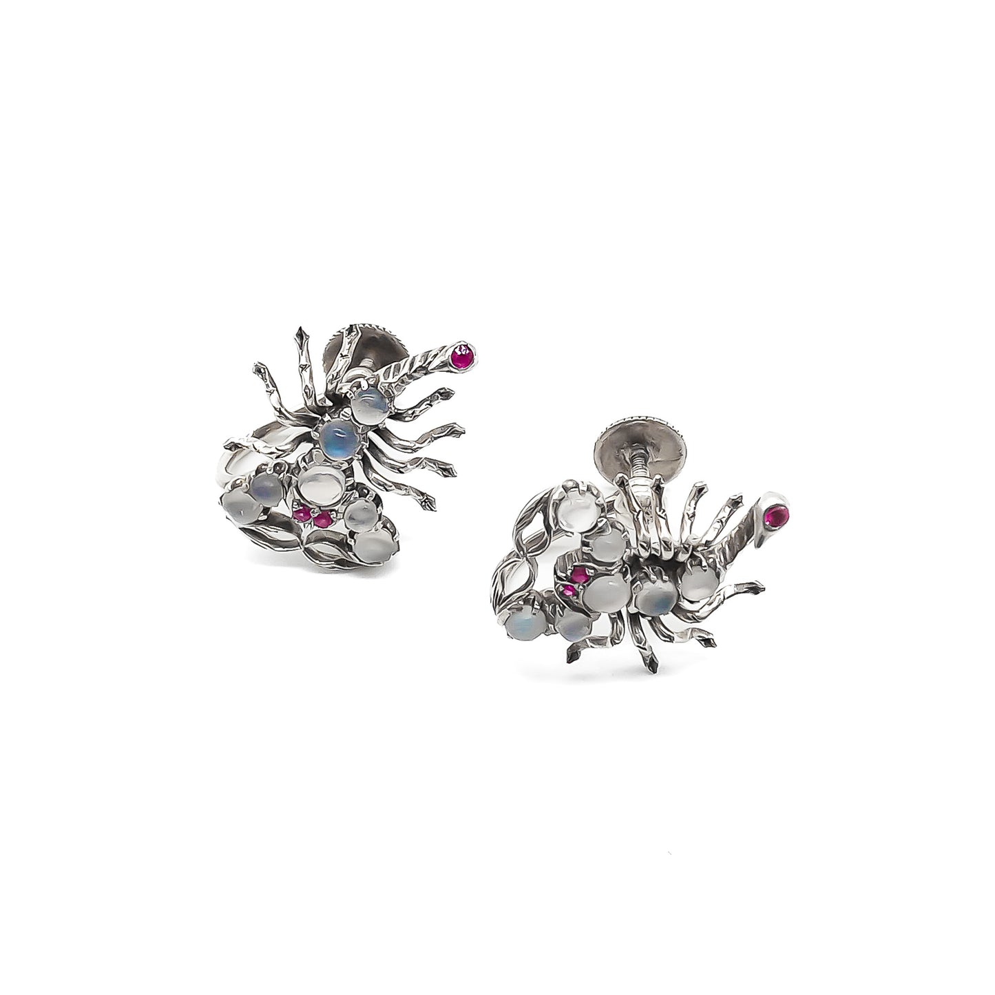 Charming silver scorpion earrings, each set with seven moonstones, ruby eyes and a ruby set in the tail. Screw-on backs.
Circa 1930’s