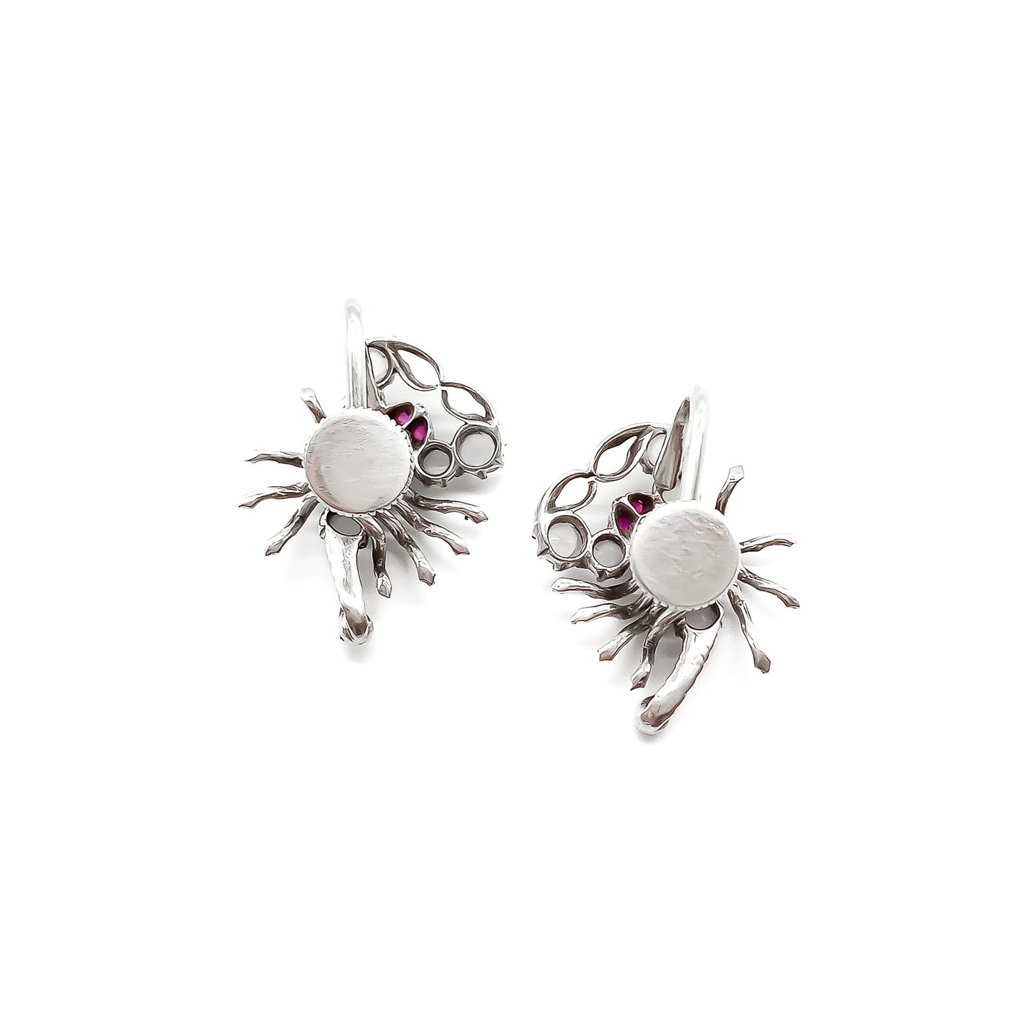 Charming silver scorpion earrings, each set with seven moonstones, ruby eyes and a ruby set in the tail. Screw-on backs.
Circa 1930’s