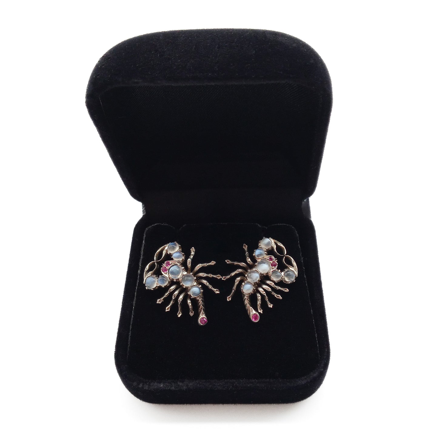 Charming silver scorpion earrings, each set with seven moonstones, ruby eyes and a ruby set in the tail. Screw-on backs.
Circa 1930’s
