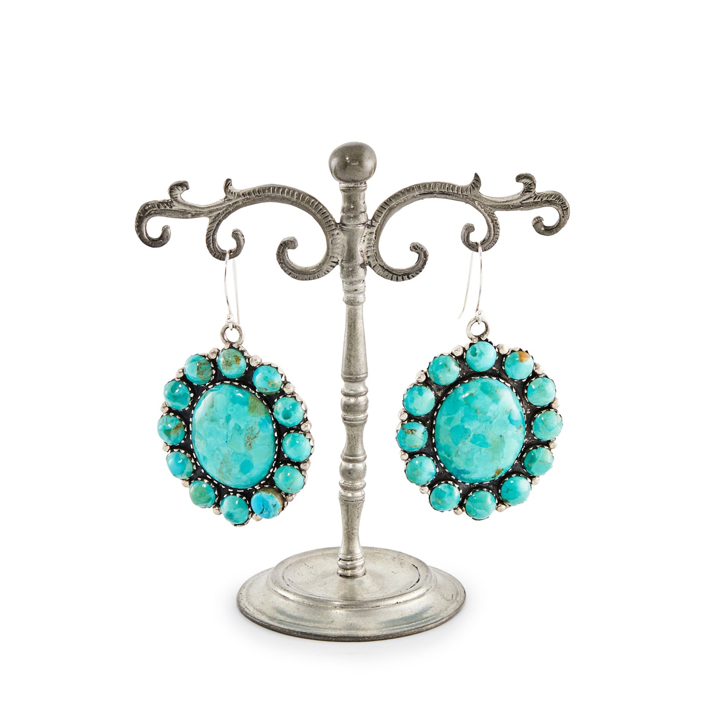 Stunning large handmade sterling silver Native American earrings with natural, vibrant turquoise stones in a cluster petit point setting.
Stamped “Sterling” with a feather marking.