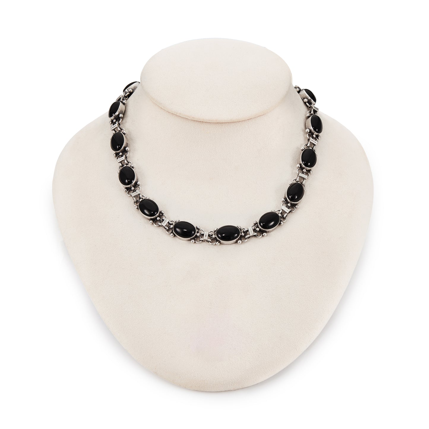 Stylish sterling silver necklace, set with fifteen oval cabochon onyx stones.