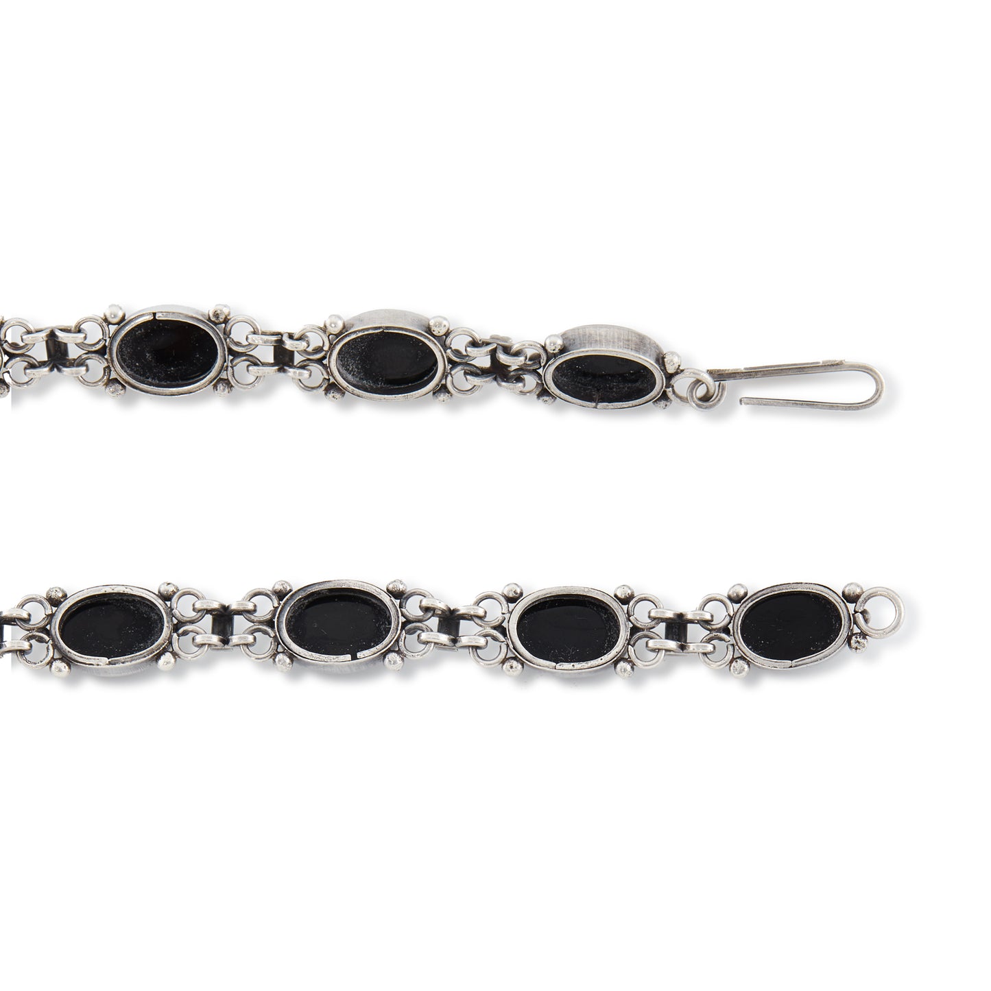 Stylish sterling silver necklace, set with fifteen oval cabochon onyx stones.