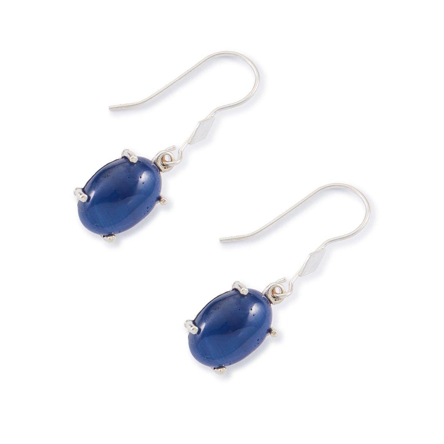 Sterling silver drop earrings, each set with a deep-blue cabochon star sapphire.