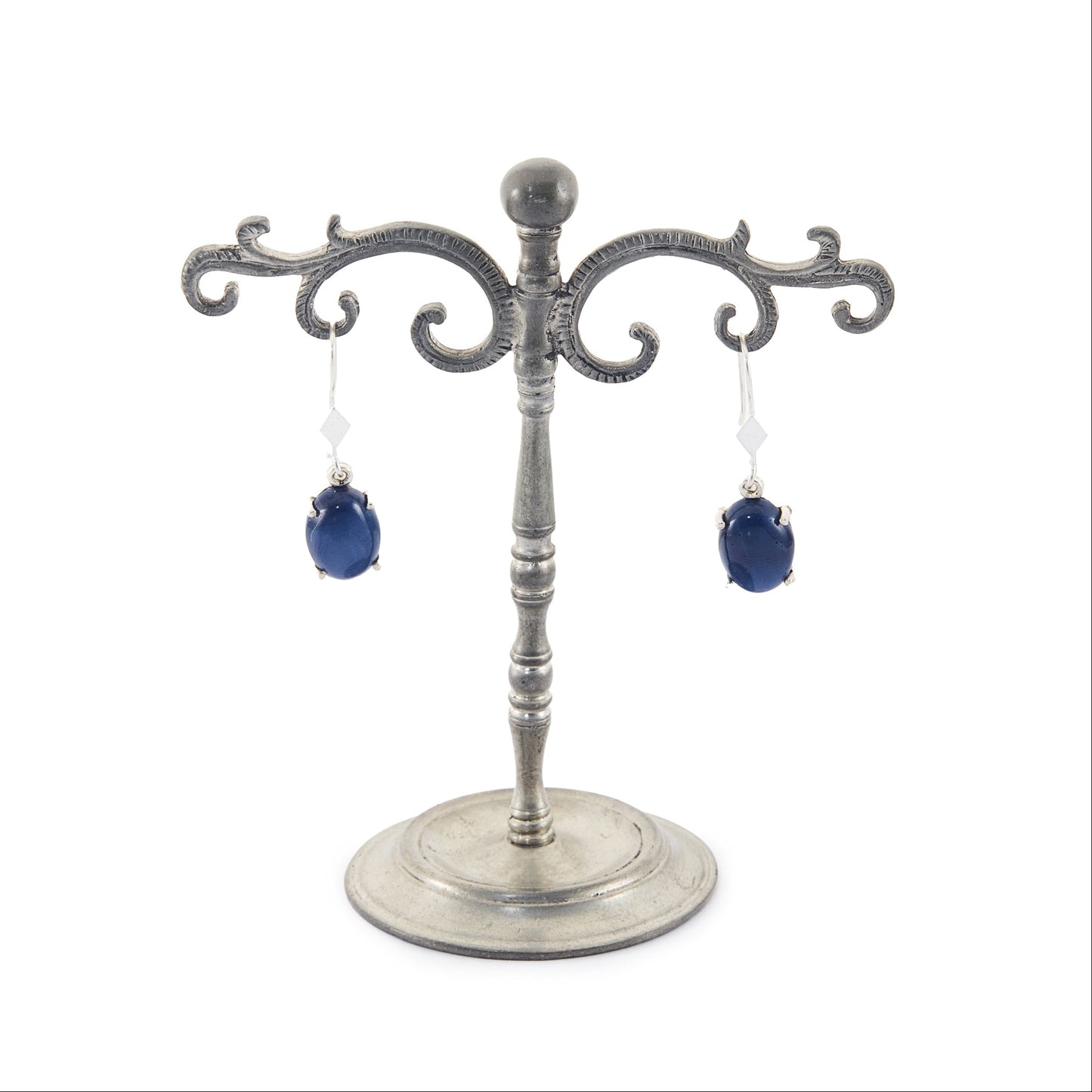 Sterling silver drop earrings, each set with a deep-blue cabochon star sapphire.