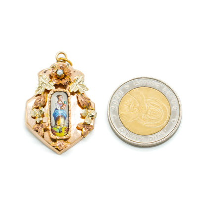 Pretty Victorian rose gold pendant set with a hand-painted porcelain miniature depicting a lady, surrounded by rose and yellow gold flowers containing one seed pearl.