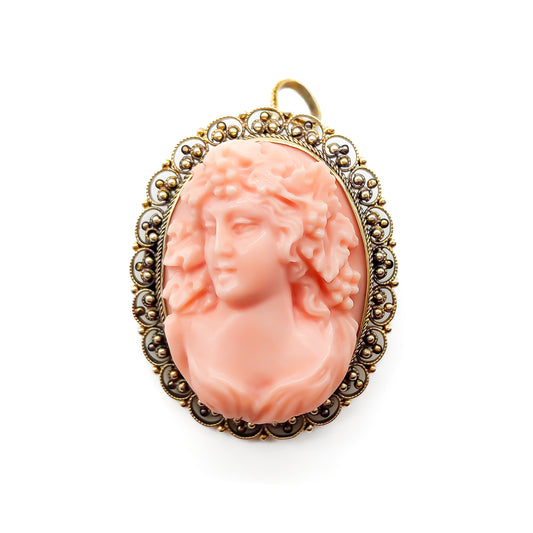 Beautifully hand-carved Victorian coral cameo set in a 14ct yellow gold filigree frame. Can be worn as either a pendant or brooch.