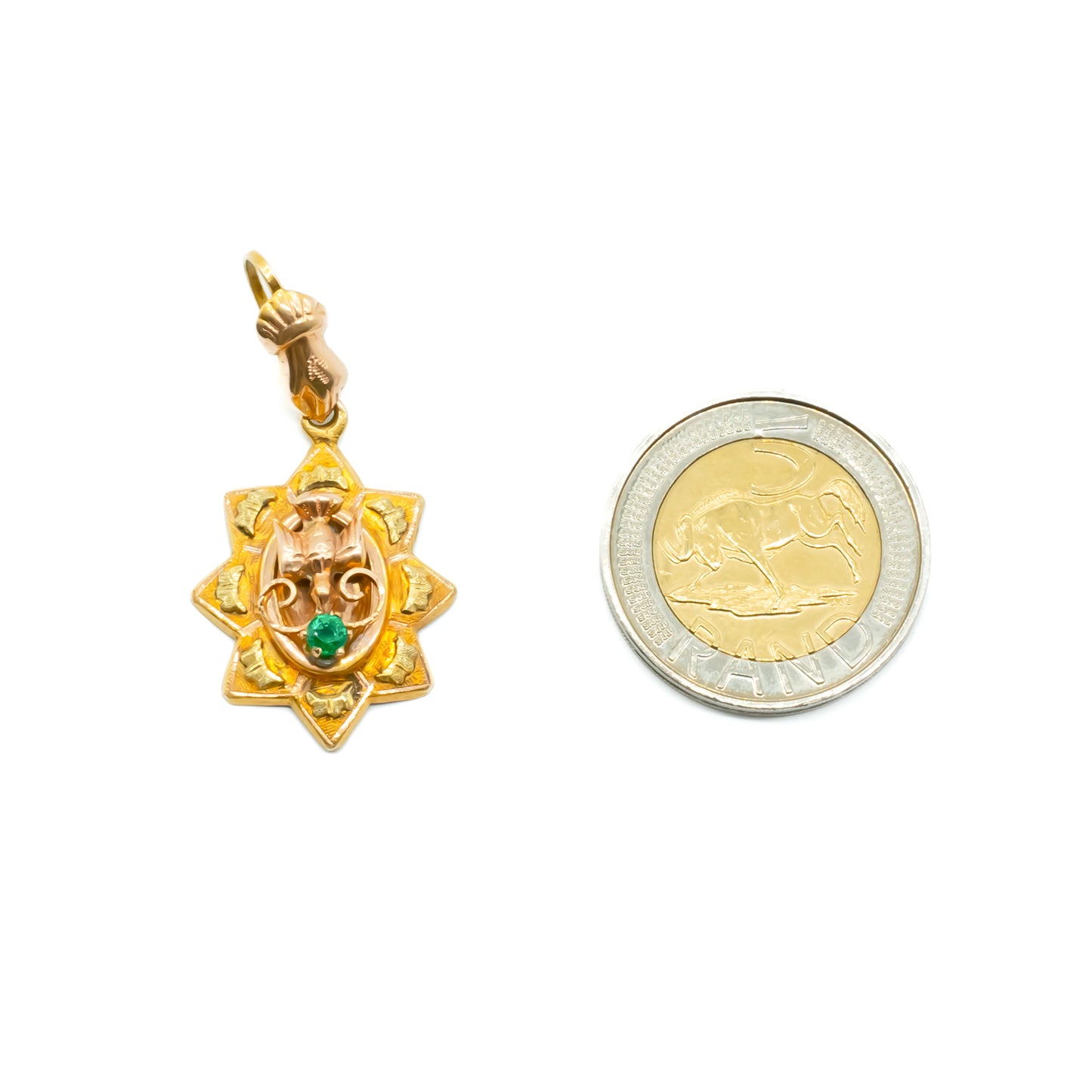 Exquisite Victorian 15ct rose and yellow gold pendant depicting a hand and dove, set with a faceted emerald.