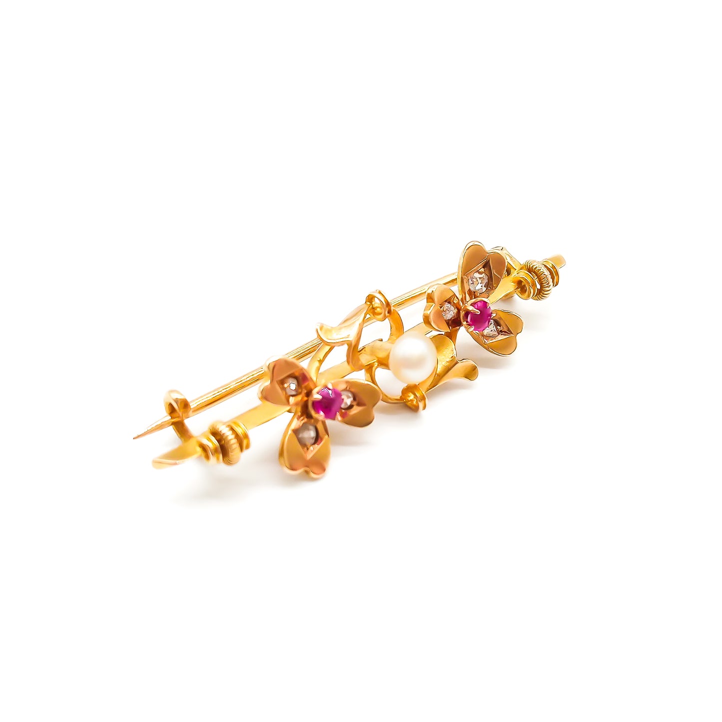 Dainty 15ct gold Victorian bar brooch set with two rubies, six small diamonds and a pearl in a clover leaf setting.