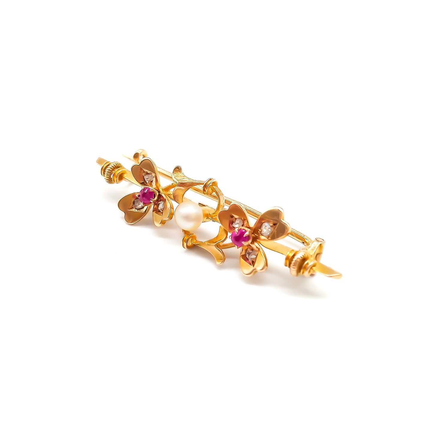 Dainty 15ct gold Victorian bar brooch set with two rubies, six small diamonds and a pearl in a clover leaf setting.
