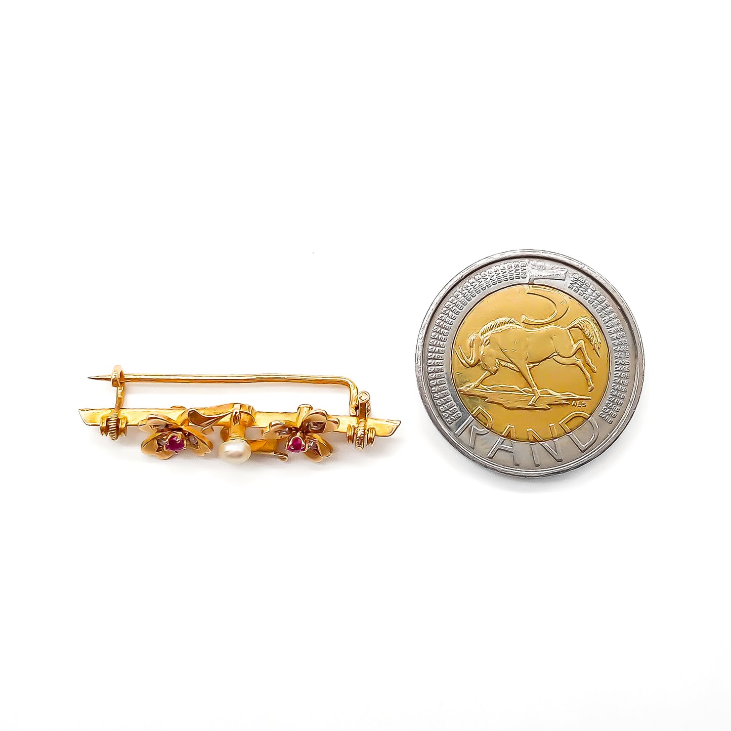 Dainty 15ct gold Victorian bar brooch set with two rubies, six small diamonds and a pearl in a clover leaf setting.