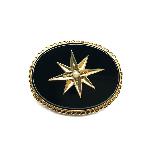 Exquisite Victorian 15ct gold mourning brooch set with an oval onyx disc centred by a star motif containing a single seed pearl. Lock of hair and glass intact.