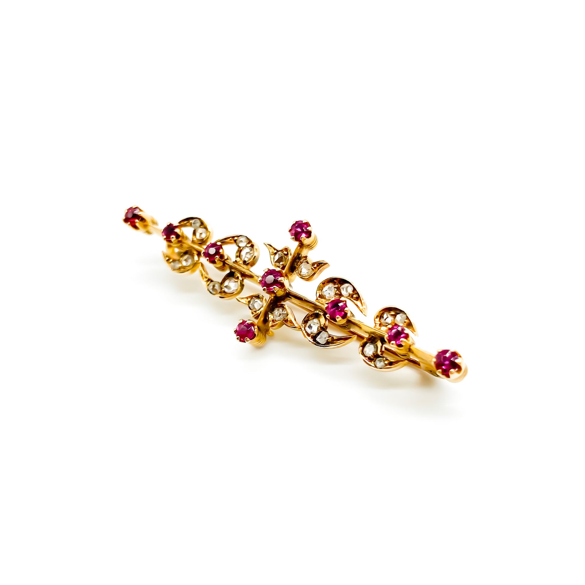 Dainty Victorian 18ct gold bar brooch set with nine rubies and twenty mine cut diamonds.