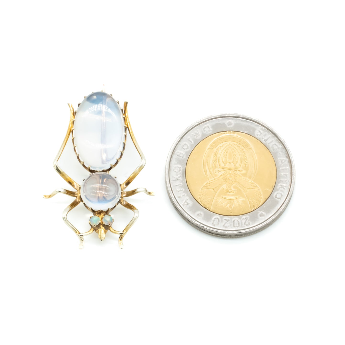 Charming Victorian 9ct gold insect brooch with a moonstone cabochon body, and fluorescent opal eyes.