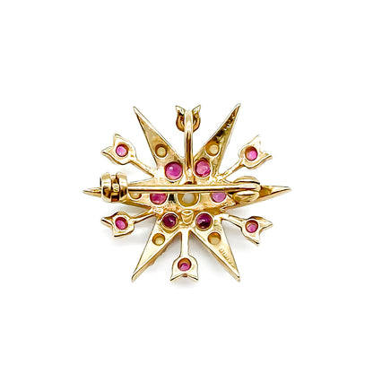Delicate Victorian 9ct yellow gold star brooch set with twelve faceted rubies and seed pearls. 