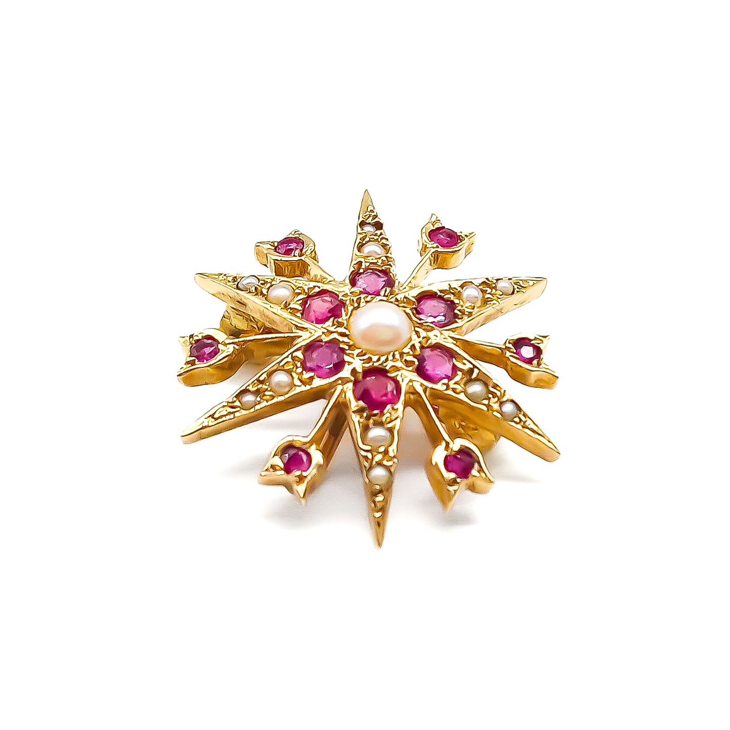 Delicate Victorian 9ct yellow gold star brooch set with twelve faceted rubies and seed pearls.