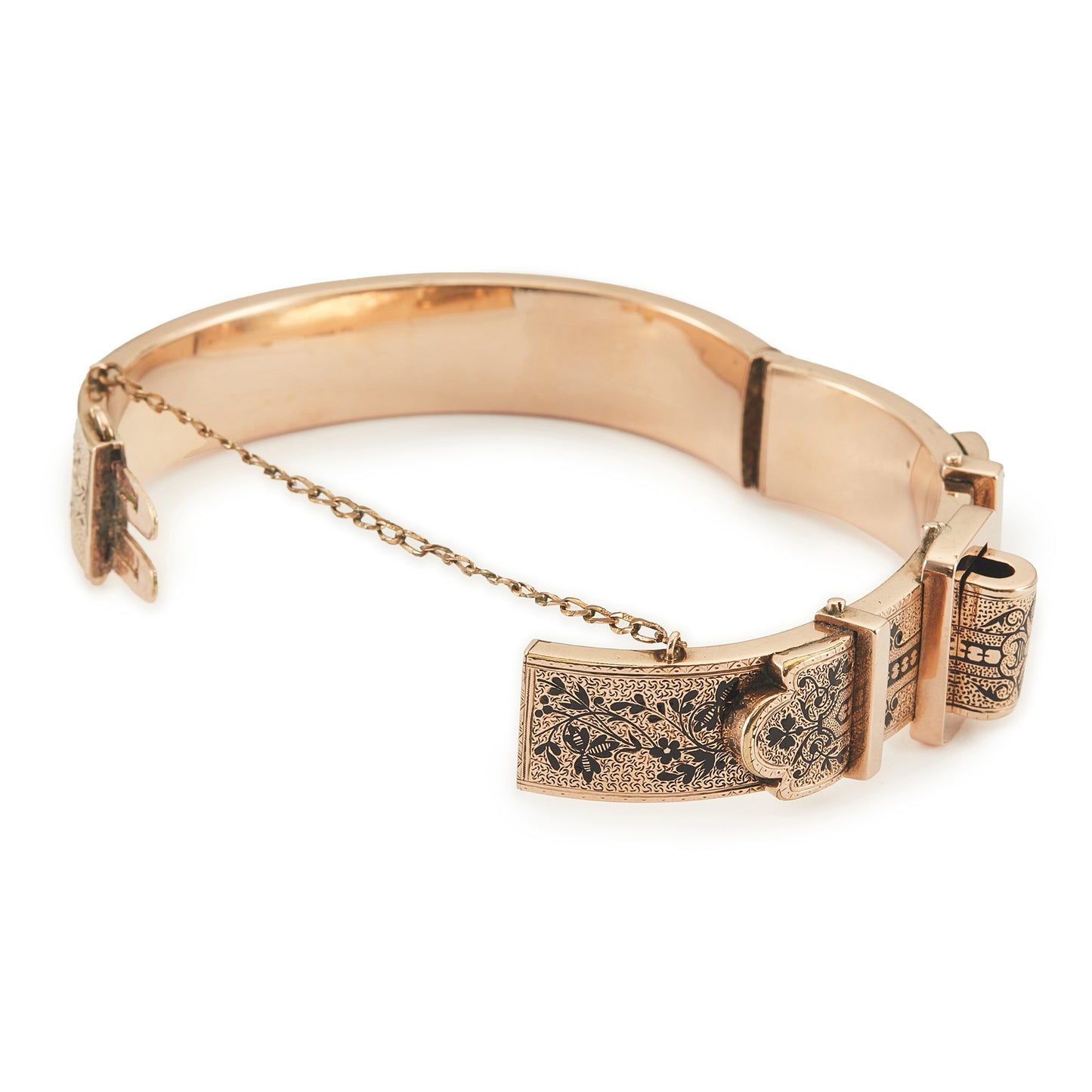 Exquisite Victorian 9ct rose gold hollow buckle bangle, embellished with beautiful intricate black enamel floral design. Opens with hinge mechanism. Safety chain attached.