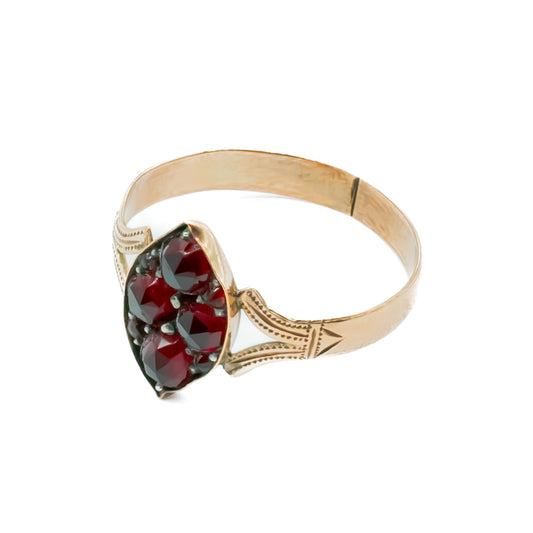 Dainty Victorian 9ct rose gold ring set with eight deep red faceted garnets.