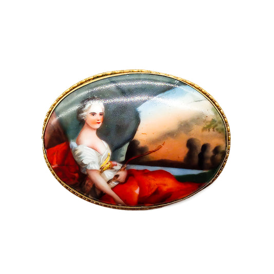 Unusually large Victorian hand painted portrait brooch depicting a lovely lady in a pastoral scene, with a brass frame.