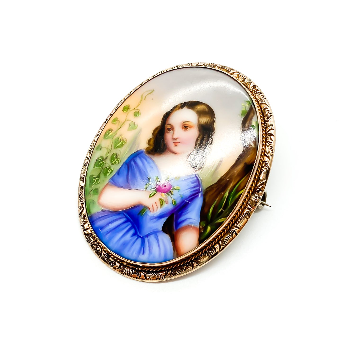 Charming Victorian hand painted porcelain brooch depicting a young girl holding a flower in a rose gold plated frame.