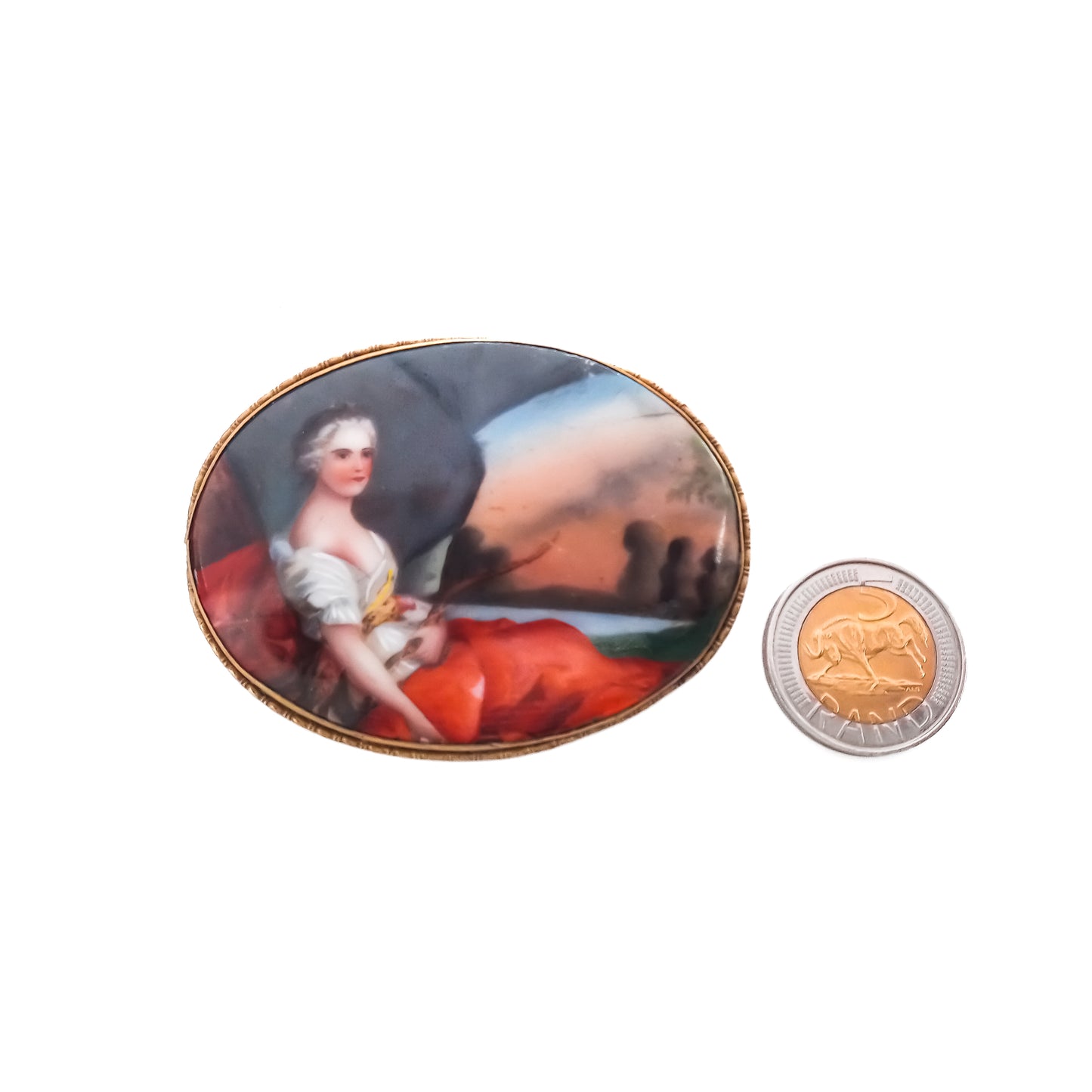Unusually large Victorian hand painted portrait brooch depicting a lovely lady in a pastoral scene, with a brass frame.