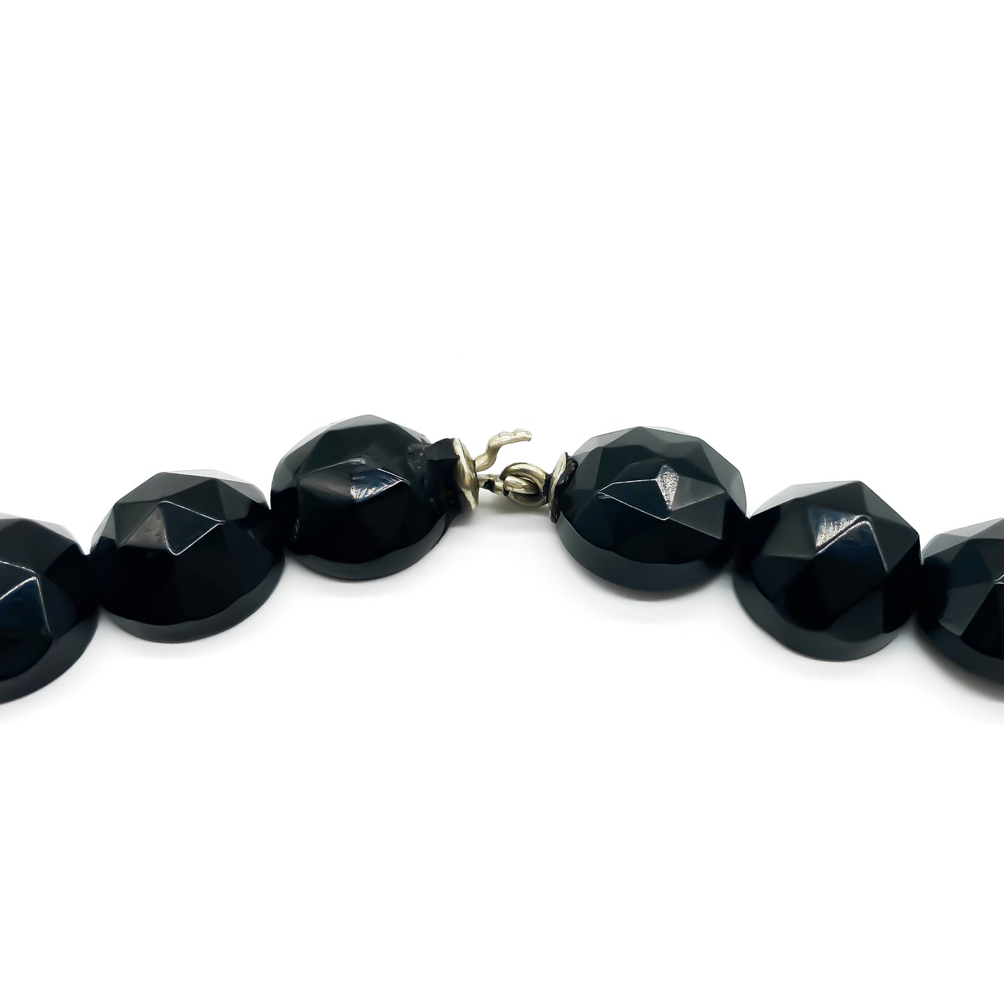 Beautifully faceted Victorian jet statement necklace with nine drops. Interconnected with metal links, the jet beads form a continuous strand that drapes gracefully around the neck.