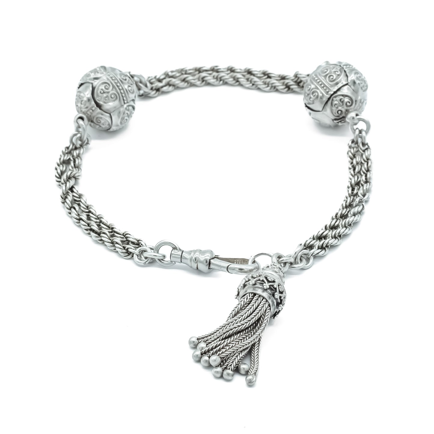 Lovely Victorian albertina bracelet with two beautifully embossed silver beads, a tassel and dog clip.