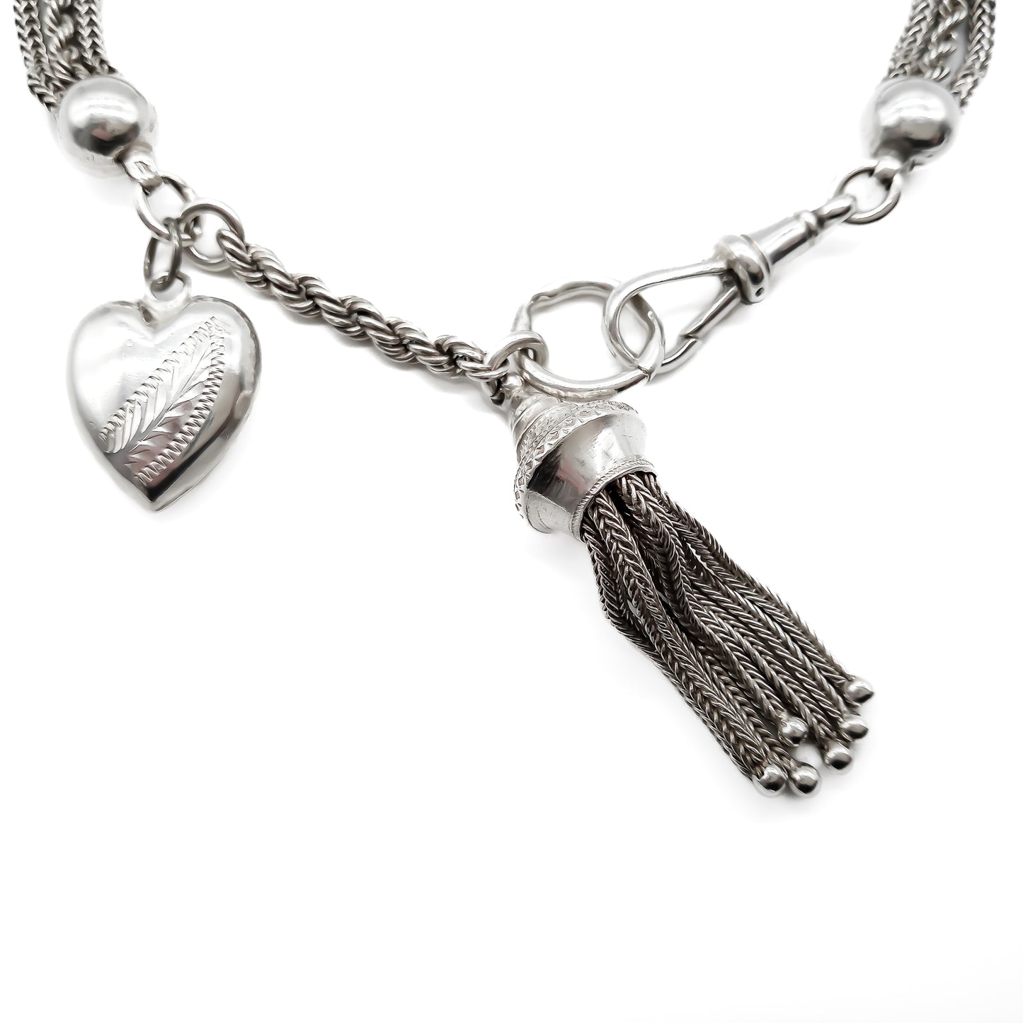 Victorian silver albertina bracelet with ornate detail, a dog clip, a tassel and a heart charm.