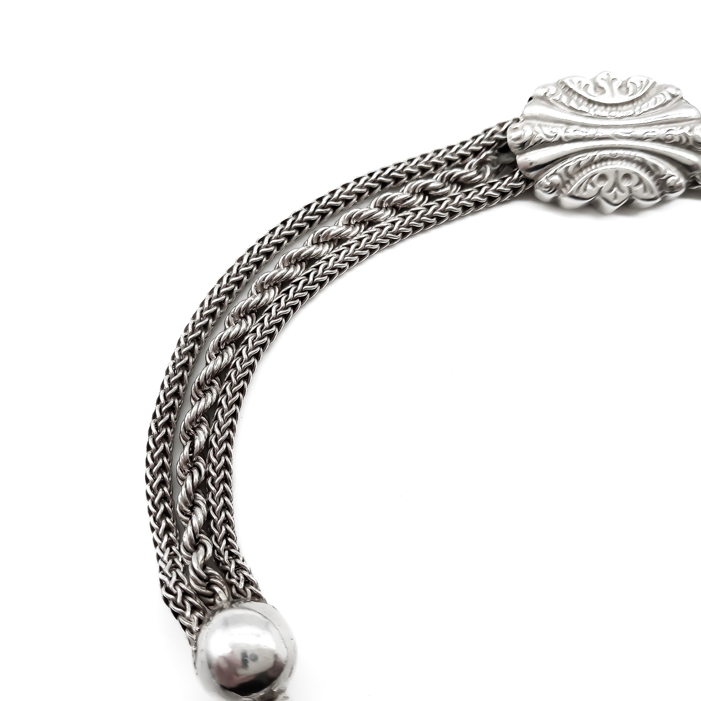 Victorian silver albertina bracelet with ornate detail, a dog clip, a tassel and a heart charm.