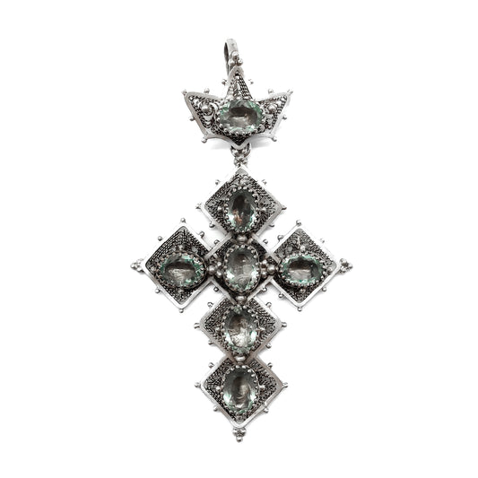 Ornate silver Victorian filigree cross pendant set with aquamarine-coloured foil backed glass.