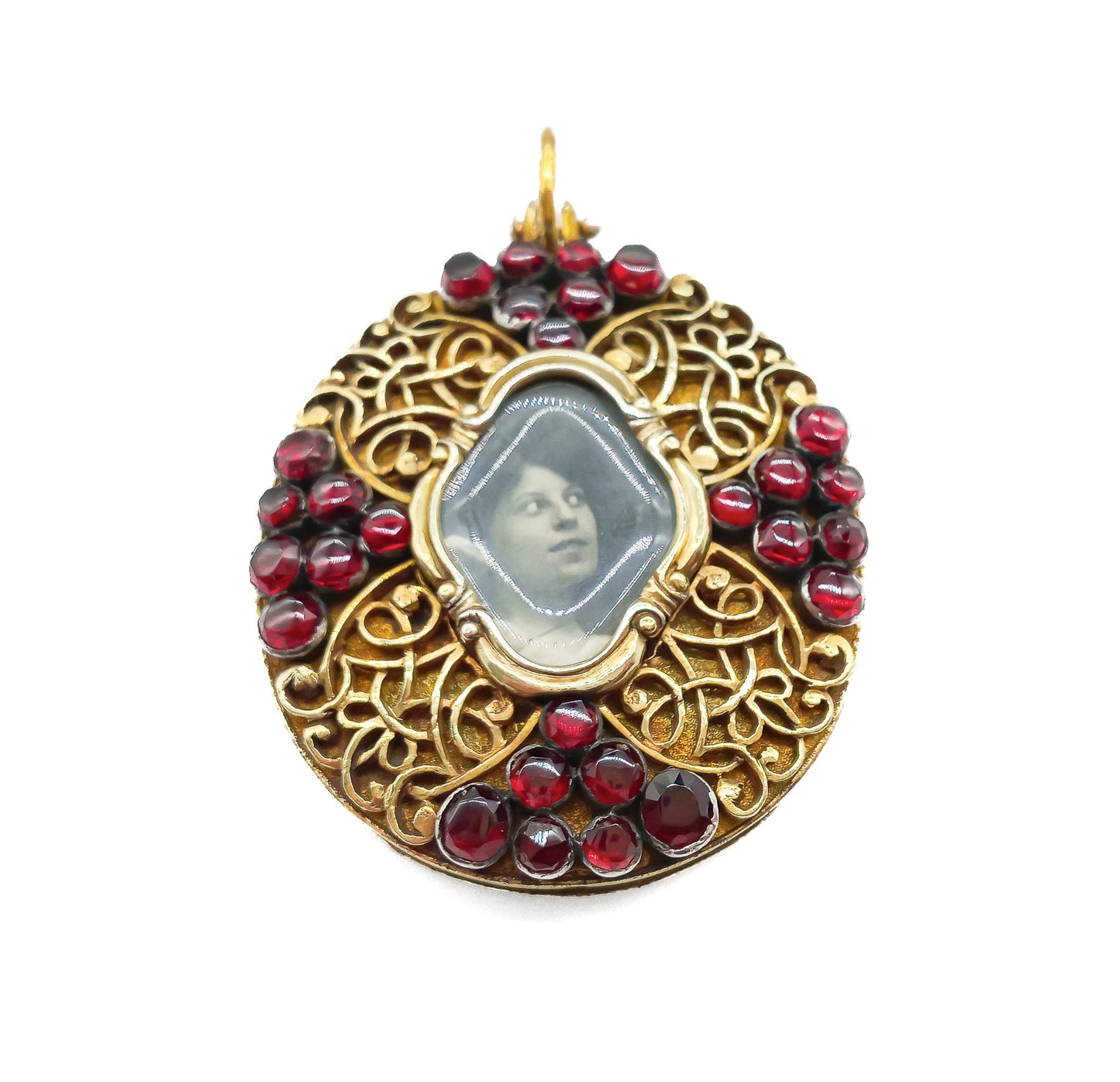 Unique Victorian silver gilt mourning pendant with ornate detail, set with twenty-eight deep red garnets.