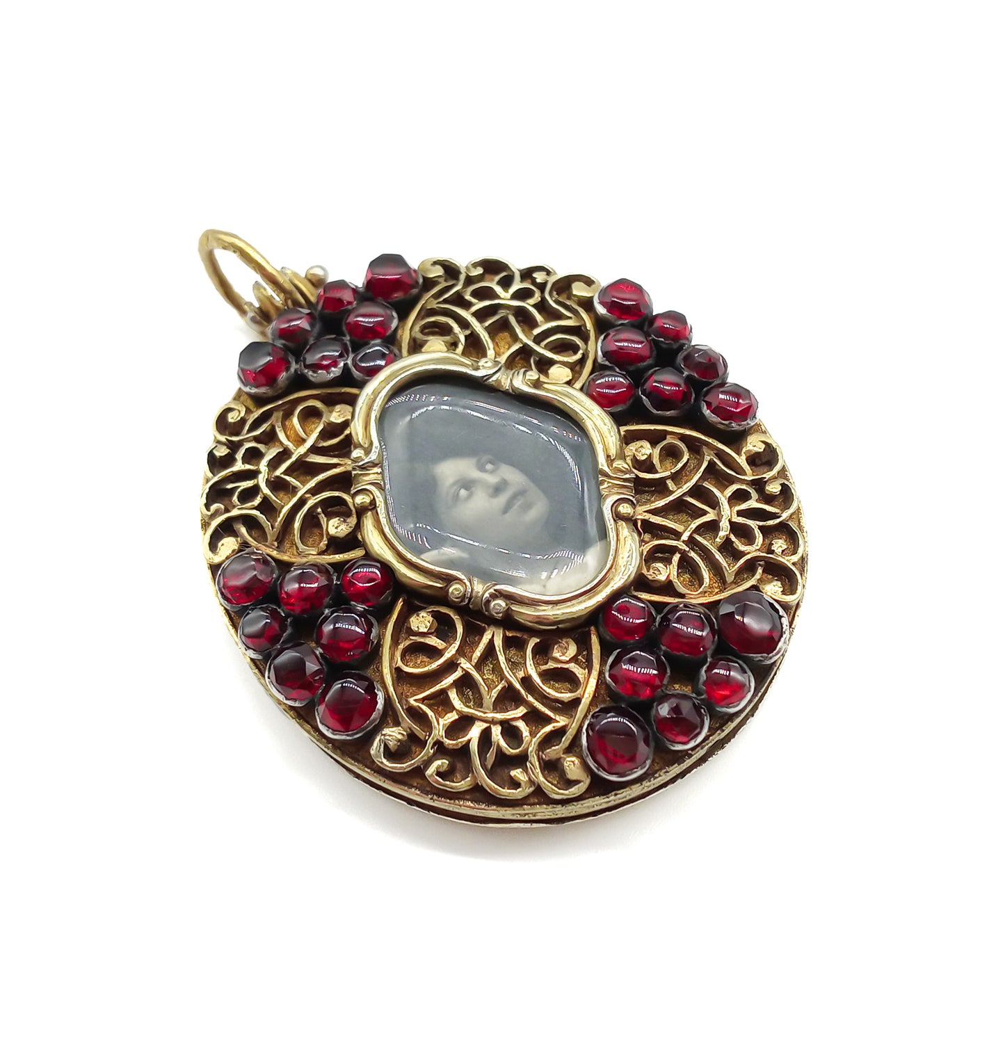 Unique Victorian silver gilt mourning pendant with ornate detail, set with twenty-eight deep red garnets.