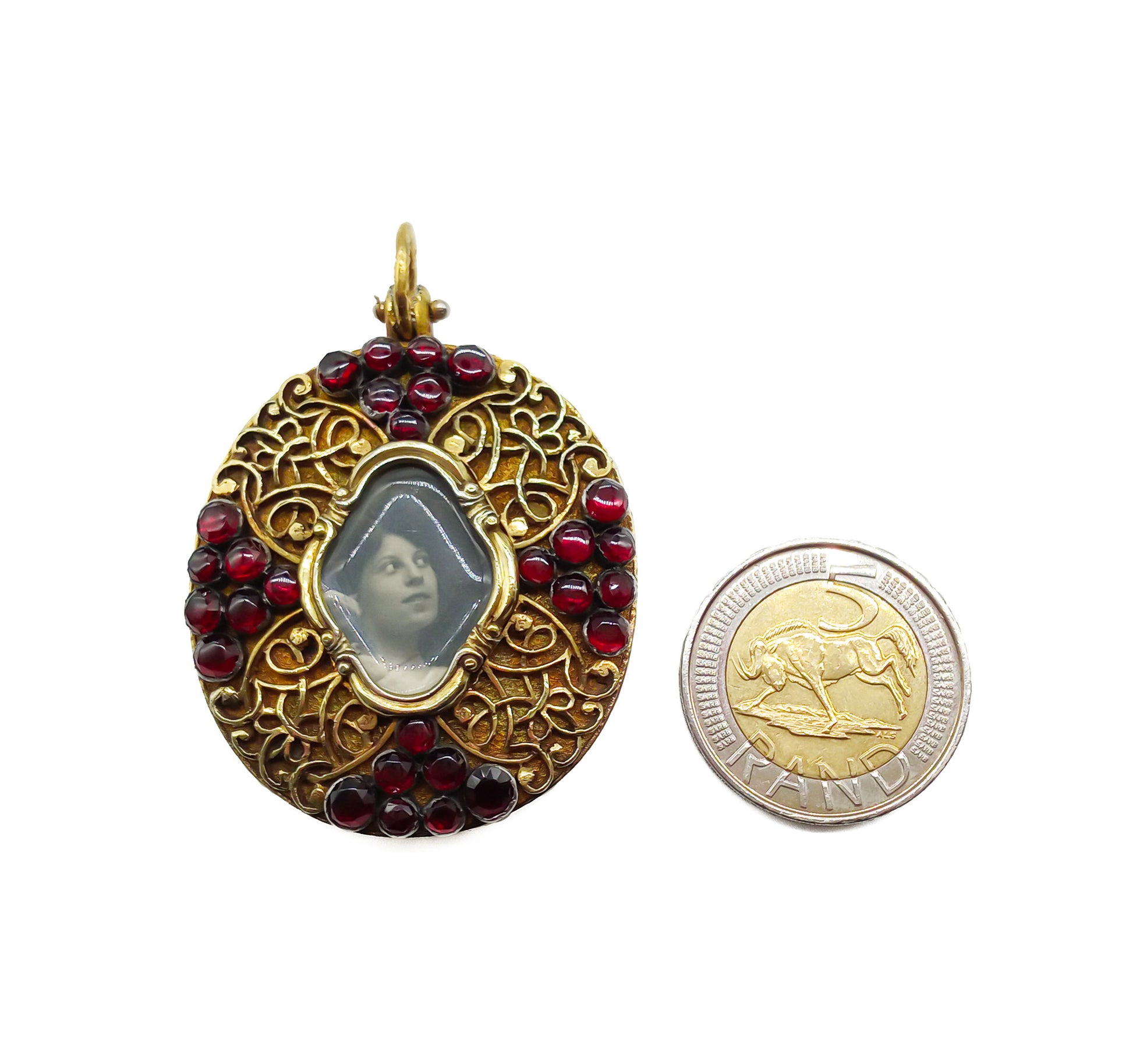 Unique Victorian silver gilt mourning pendant with ornate detail, set with twenty-eight deep red garnets.