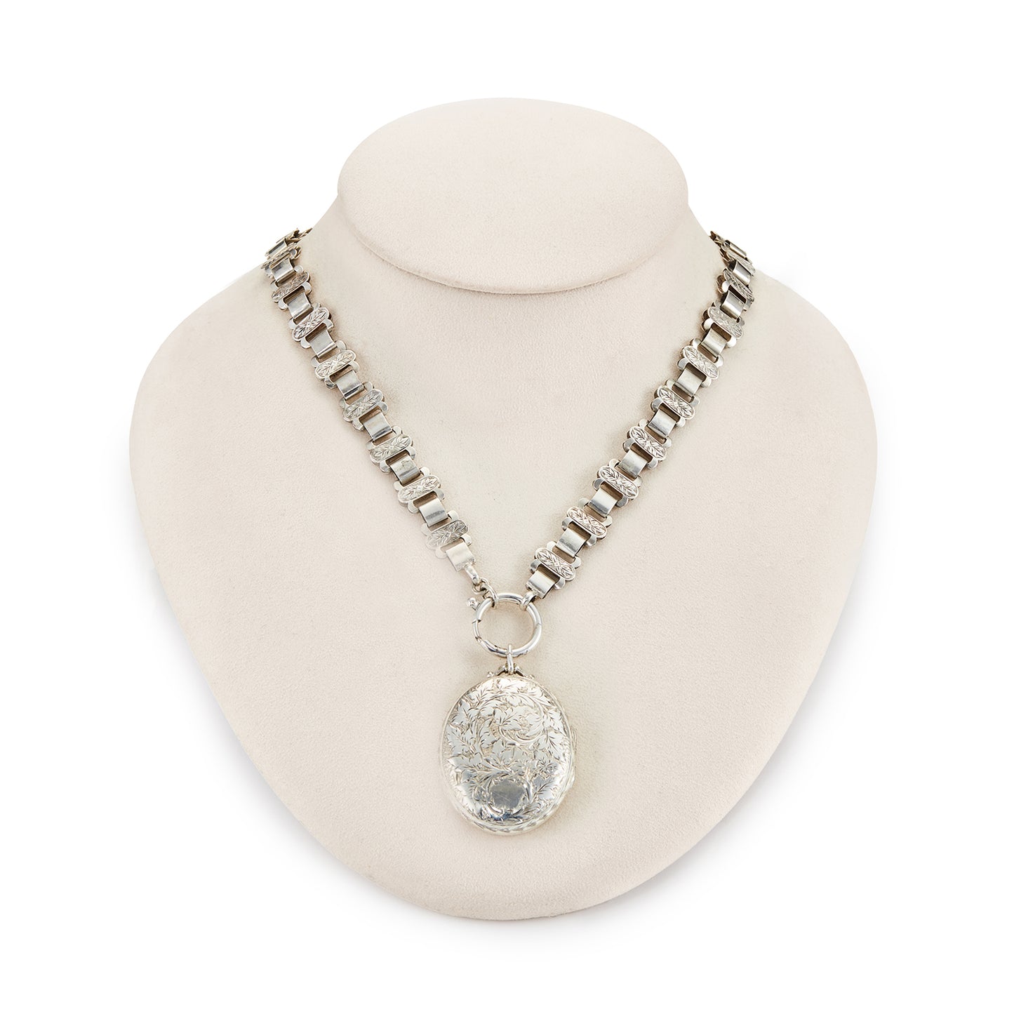 Classic Victorian silver locket on choker with ornate floral engraving.