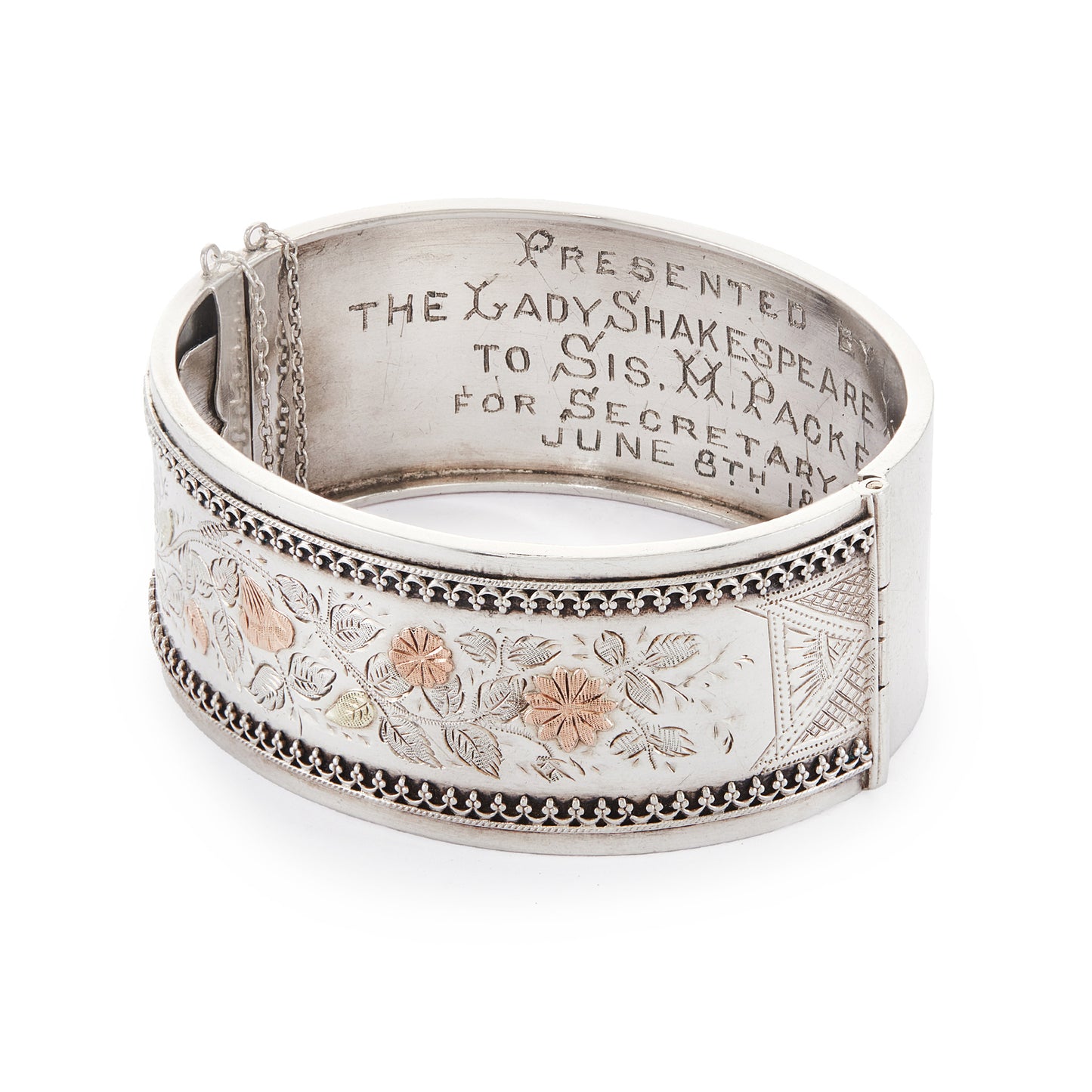 Beautiful Victorian silver and gold bangle embossed with a floral design and Etruscan detail around the rim. Safety chain attached.