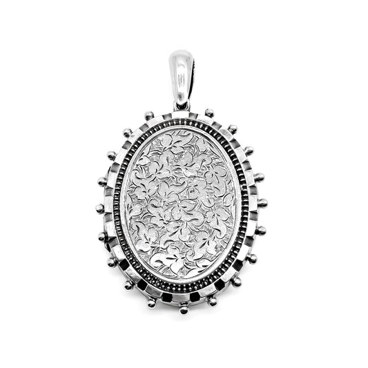 Ornate Victorian sterling silver locket with beautiful floral engraving.