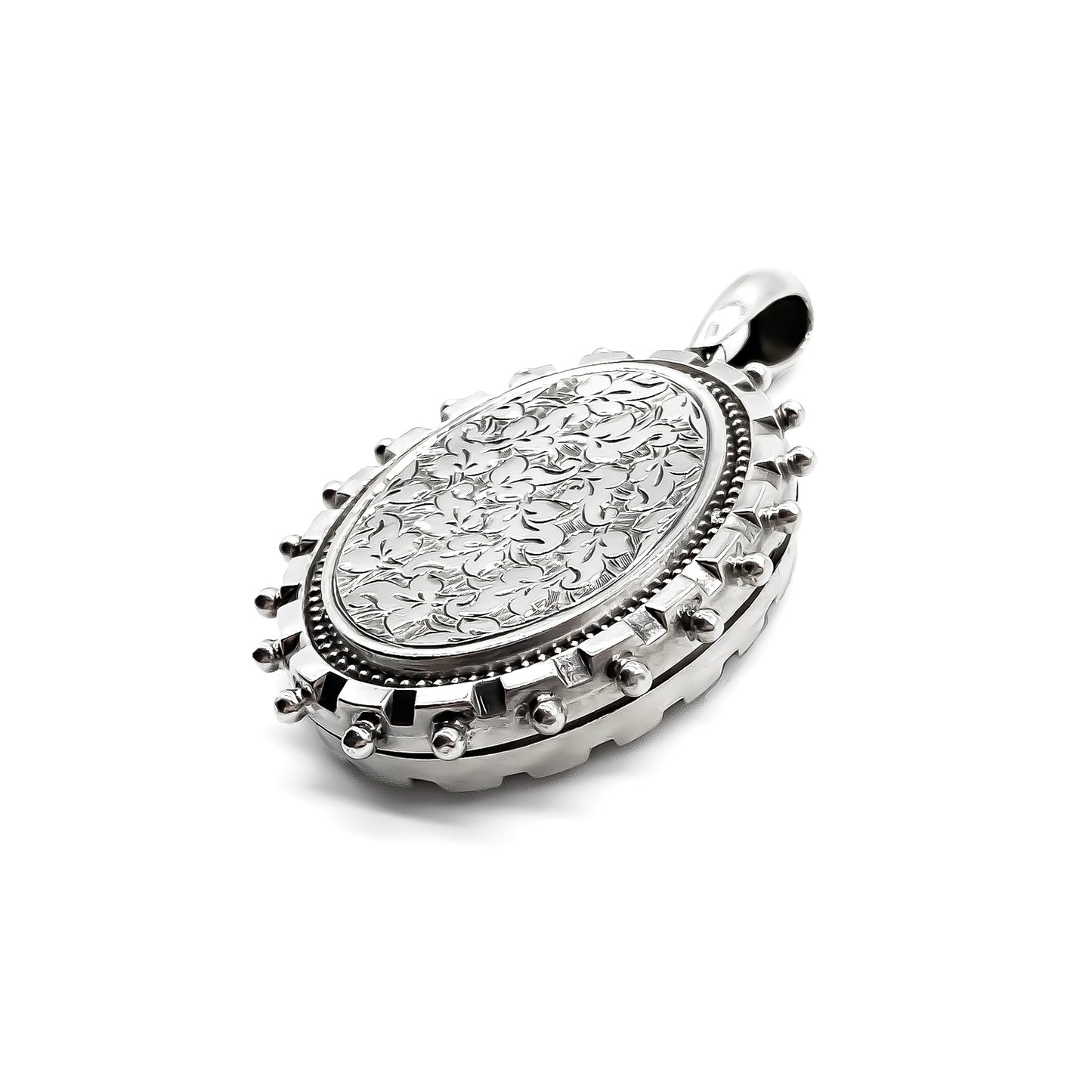 Ornate Victorian sterling silver locket with beautiful floral engraving.