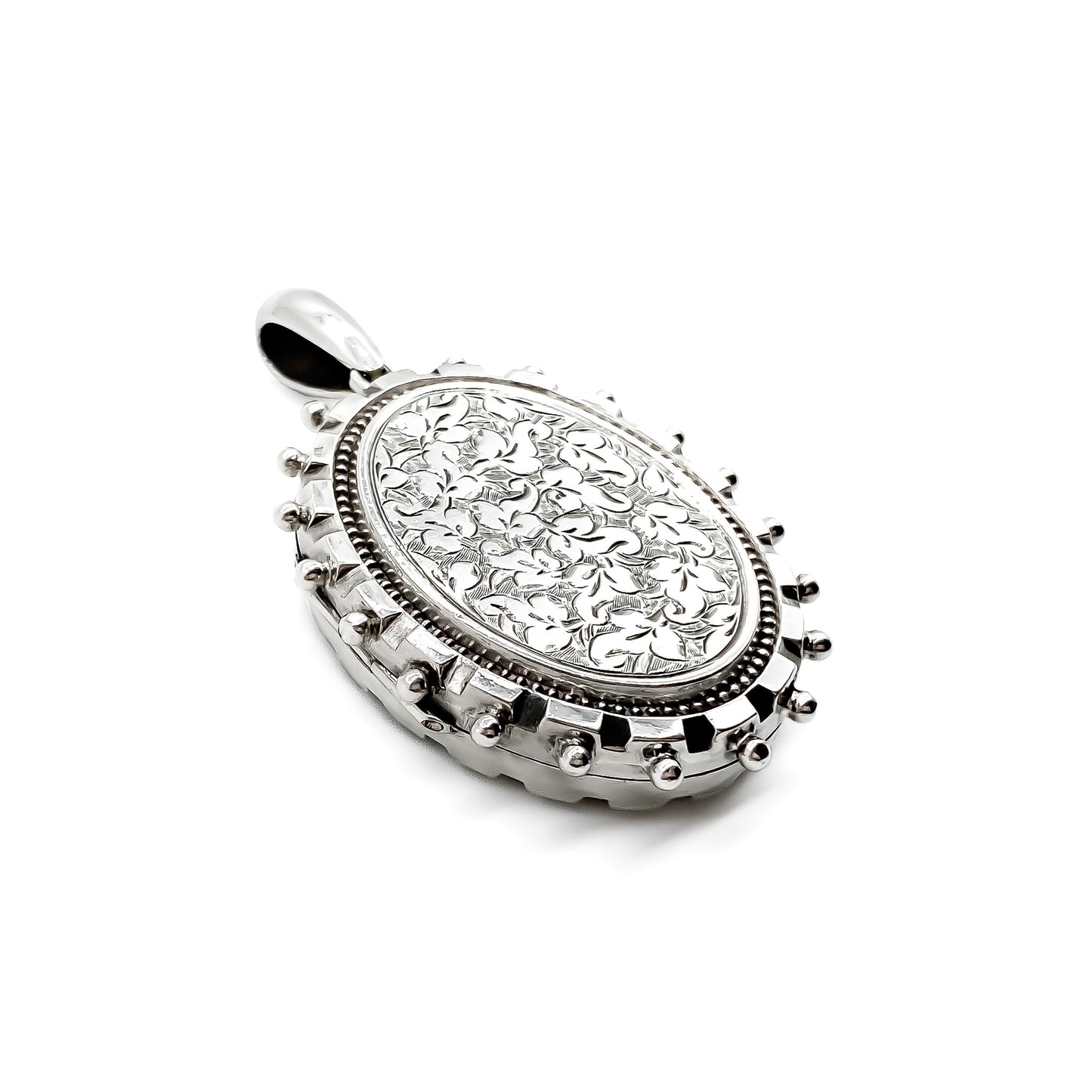 Ornate Victorian sterling silver locket with beautiful floral engraving.