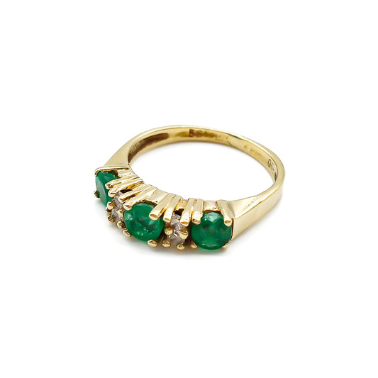 Classic vintage 14ct yellow gold ring set with three round emeralds and four small diamonds.