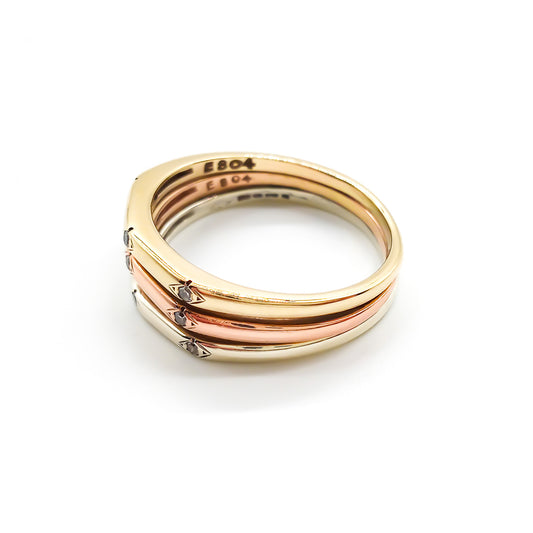 Elegant vintage 18ct yellow, white and rose gold ring set with nine small diamonds.