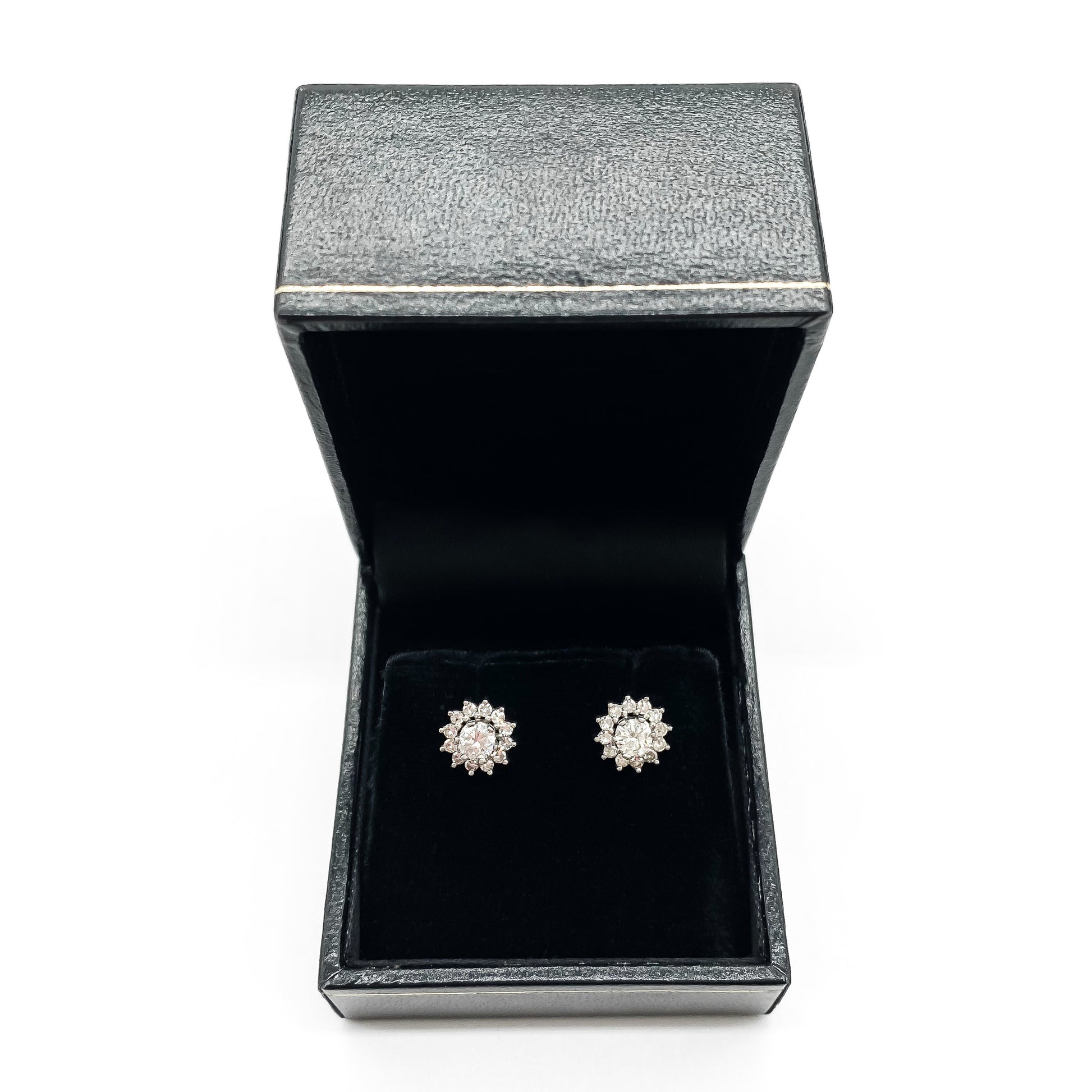 Stylish vintage 18ct white gold flower stud earrings with diamonds in a tier setting.