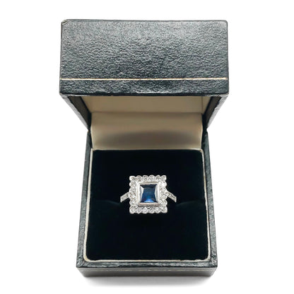 Stunning Art Deco style 18ct white gold ring with a square sapphire surrounded by twenty diamonds and ten smaller diamonds on the shank.