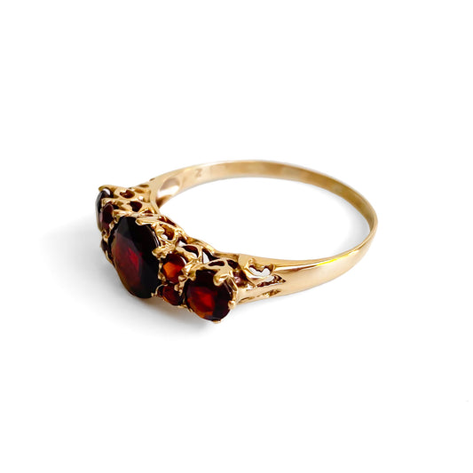 Lovely vintage 9ct yellow gold ring set with seven deep red faceted garnets. England.